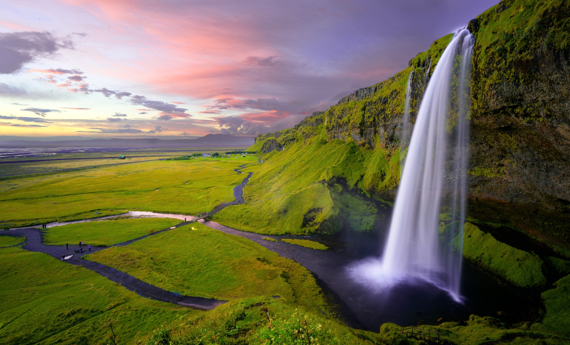 water fall with grass and sunset sky